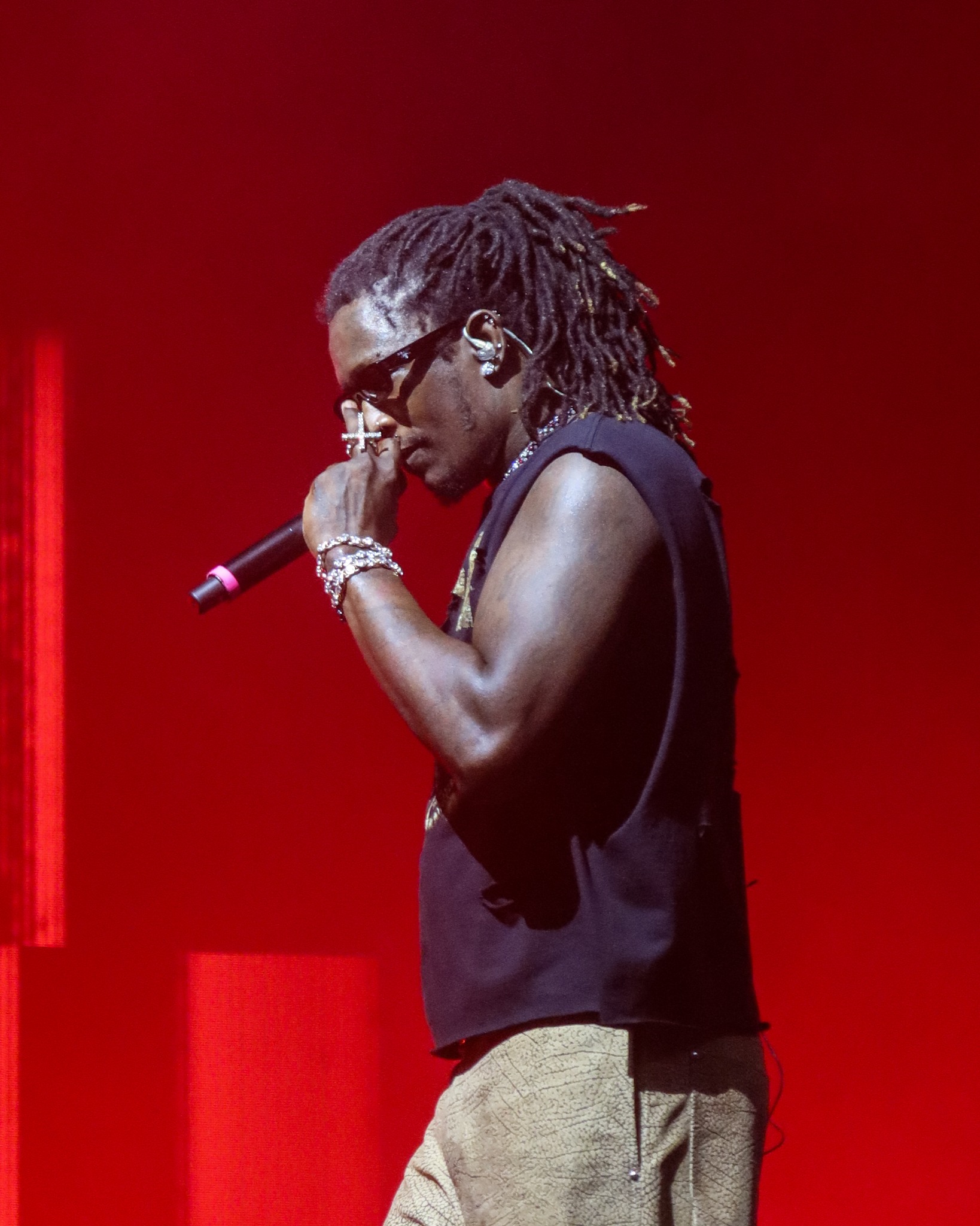 Young Thug performing against vivid red stage lighting