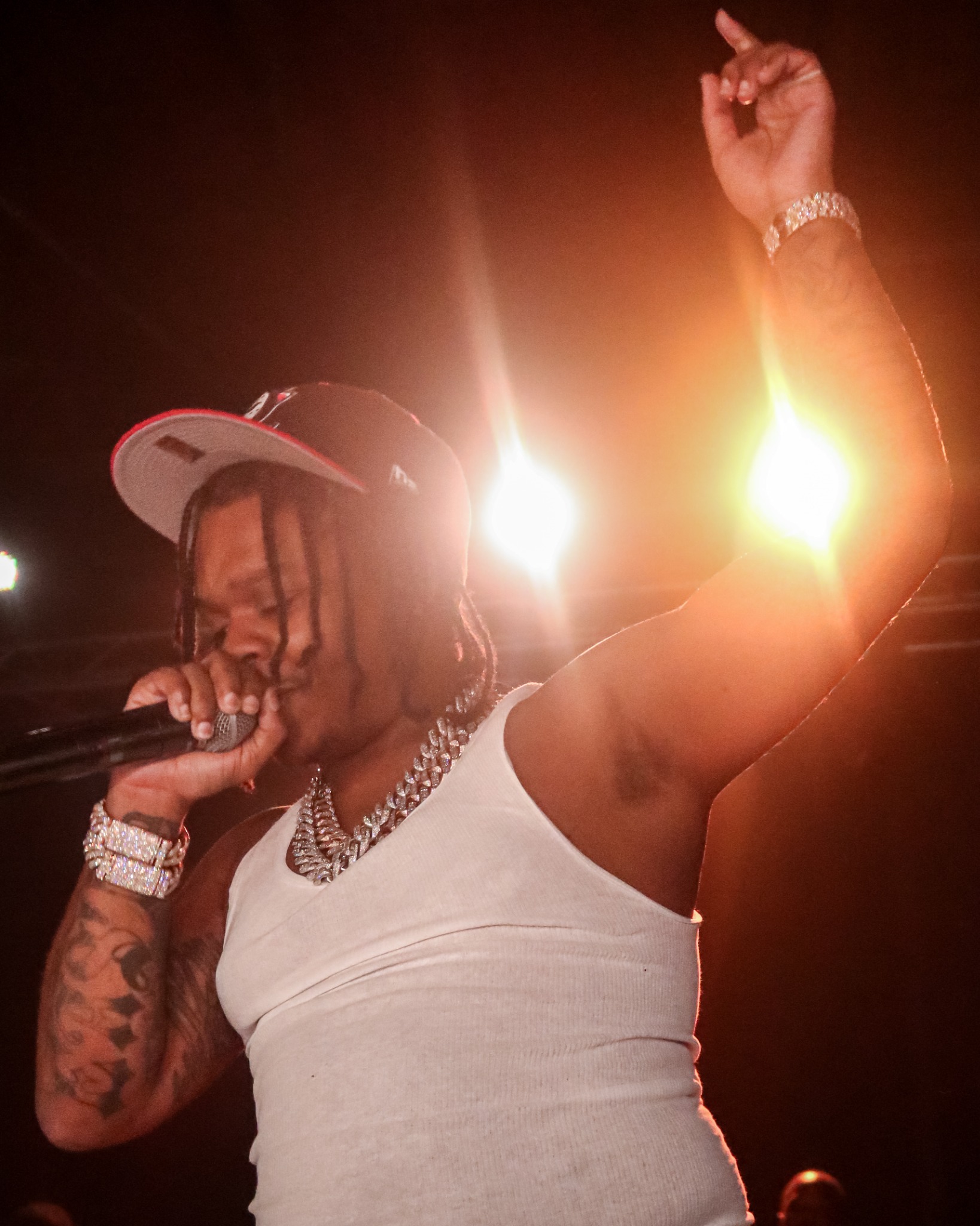 42 Dugg performing with one arm raised under stage lights